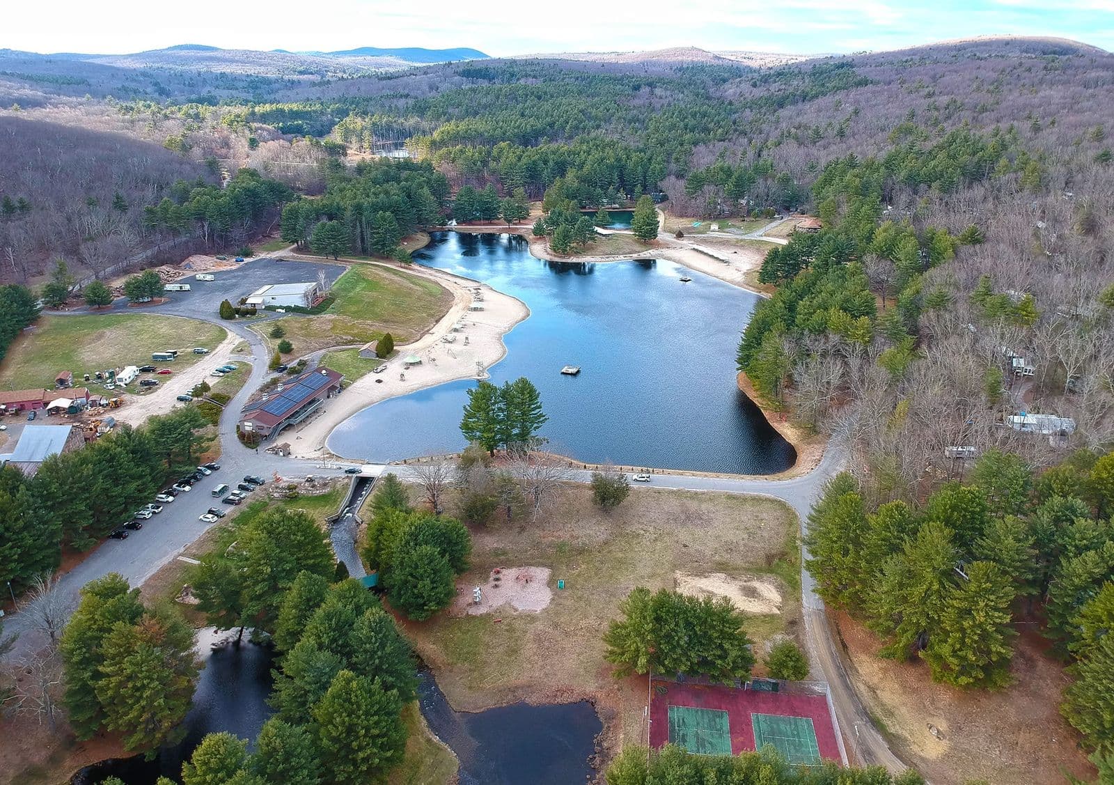 Aerial view of the lake, beaches, campground and tennis courts in the hills