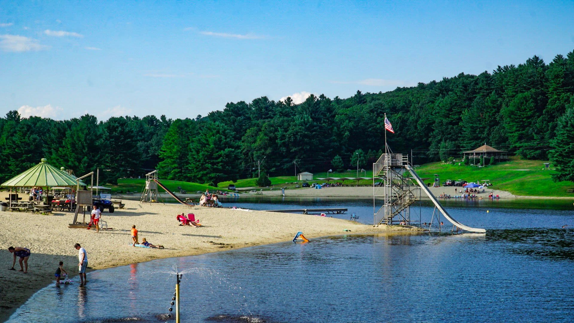 The sandy beach, cabanas and water slide on the Sun Valley lake